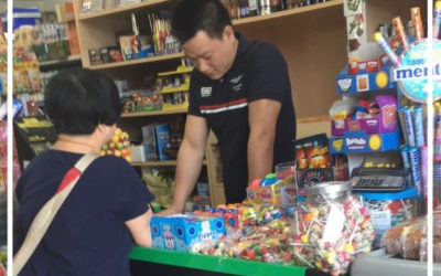 Chinese man reading One Wish leaflet in Cantonese